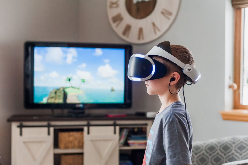 A young boy using a VR headset, fully engaged in a virtual reality experience indoors. — A Strong And Trustworthy Data Server