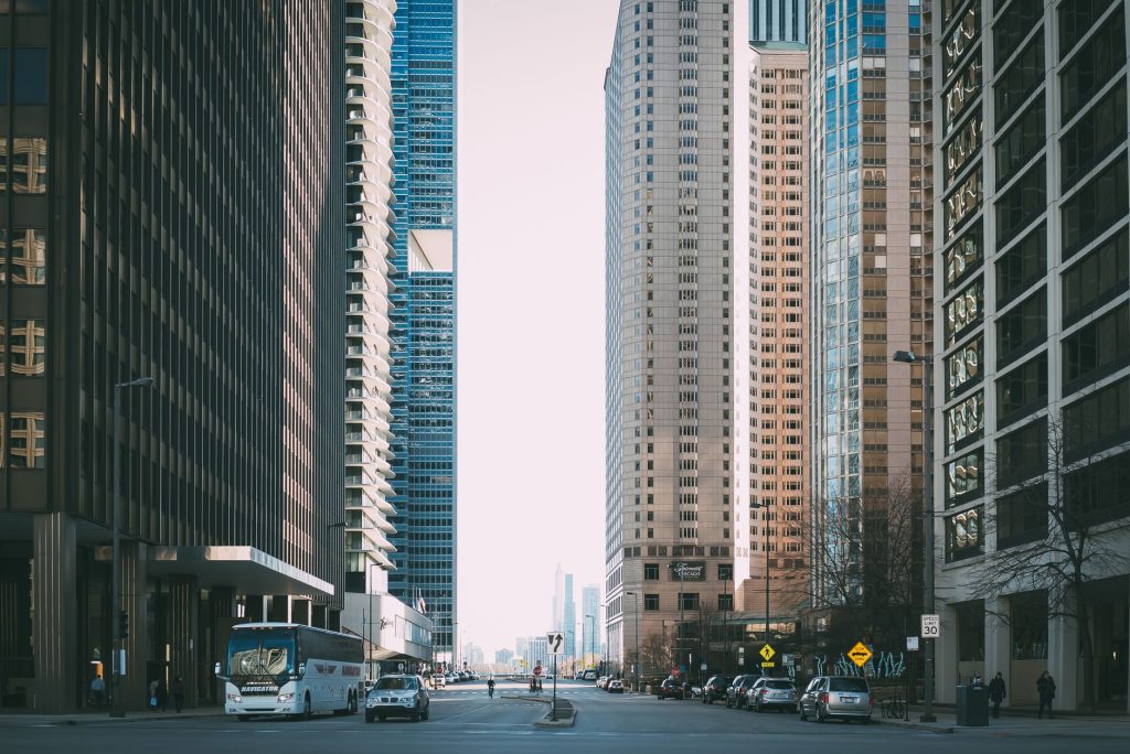 Vibrant city street scene with tall skyscrapers and city life full of cars and pedestrians. — Bondage Bliss: Navigating the W