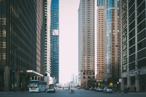 Vibrant city street scene with tall skyscrapers and city life full of cars and pedestrians. — Bondage Bliss: Navigating the W
