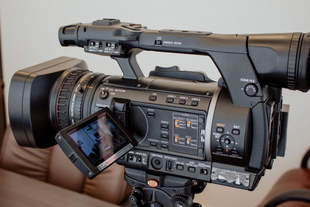 High-quality close-up of a professional video camera setup indoors, ideal for media-related work. — Bringing Fans Closer to t