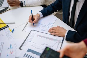 Professionals analyzing financial charts in a corporate setting. — DaaS for Small and Medium-sized Enterprises: Cost-effectiv