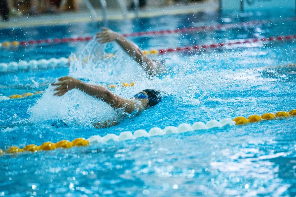 Dynamic shot of swimmers racing in a competitive swimming pool, emphasizing speed and skill. — Discover the Ultimate Free Spo