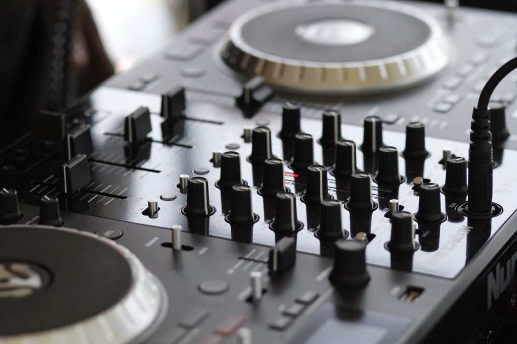 Detailed view of a professional audio mixing console with knobs and controls for sound engineering. — Emerging Chinese Electr