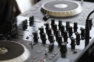 Detailed view of a professional audio mixing console with knobs and controls for sound engineering. — Emerging Chinese Electr