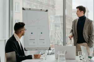 Professionals discussing a business chart in a modern office. — Get Free and Instant Instagram Likes To Increase Your Popular