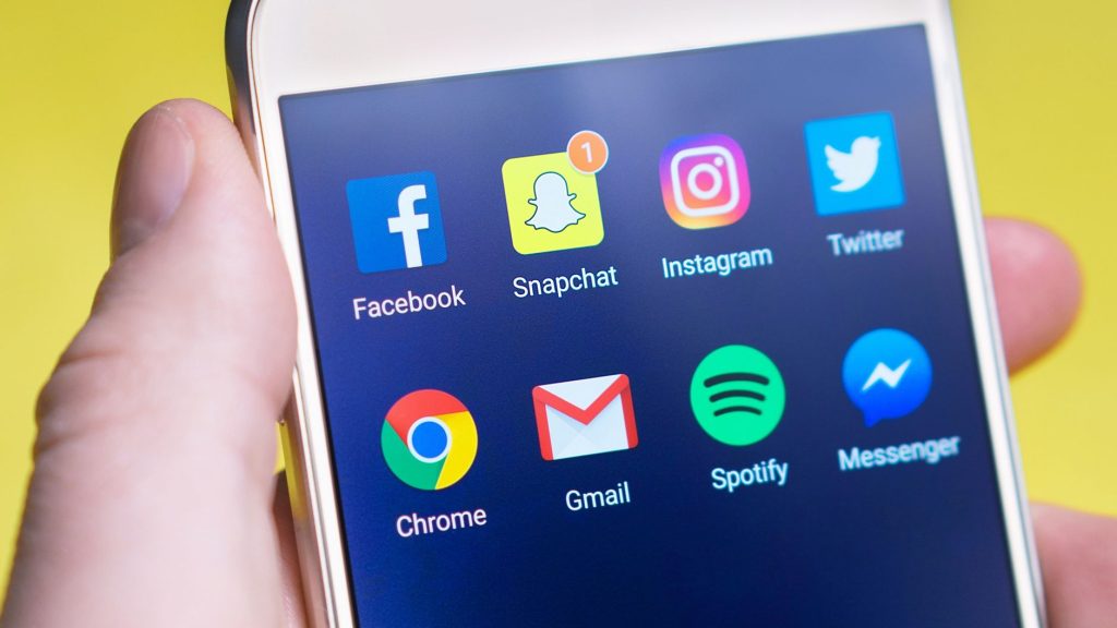 A person's hand holding a smartphone displaying social media and communication apps. — How For Anyone Who Is Filtering Job Se