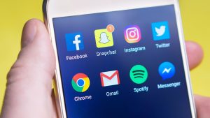 A person's hand holding a smartphone displaying social media and communication apps. — How For Anyone Who Is Filtering Job Se
