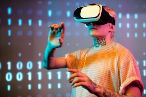 A young man interacts in virtual reality wearing a headset with a digital binary background. — How Technology is Changing the