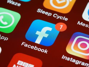 A detailed close-up of social media app icons on a smartphone screen. — How To Become A Social Butterfly Using Social Network