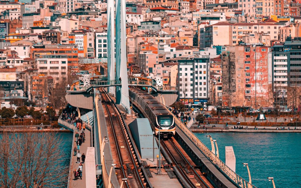 Metro train crossing a bridge in Istanbul with a vibrant cityscape backdrop. — How to Build Your Resume