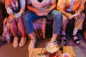 A group of teenagers enjoying a vintage gaming session indoors with snacks and drinks. — How to Find Reliable DayZ Cheat Code