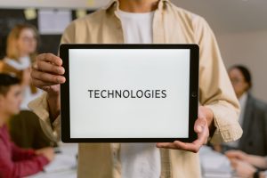 Business professionals discussing technologies, shown on a tablet in an office setting. — Importance of JavaScript Charts For