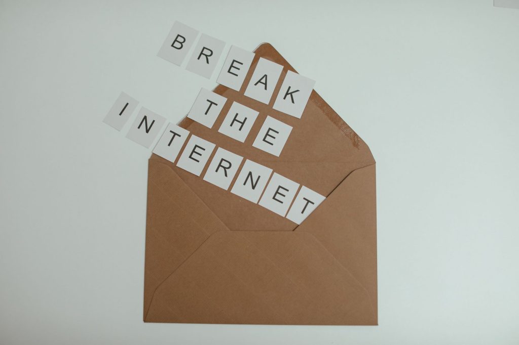 Brown envelope with tiles spelling 'Break the Internet' creates a conceptual and modern theme. — Internet Id Theft Protection