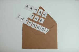 Brown envelope with tiles spelling 'Break the Internet' creates a conceptual and modern theme. — Internet Id Theft Protection