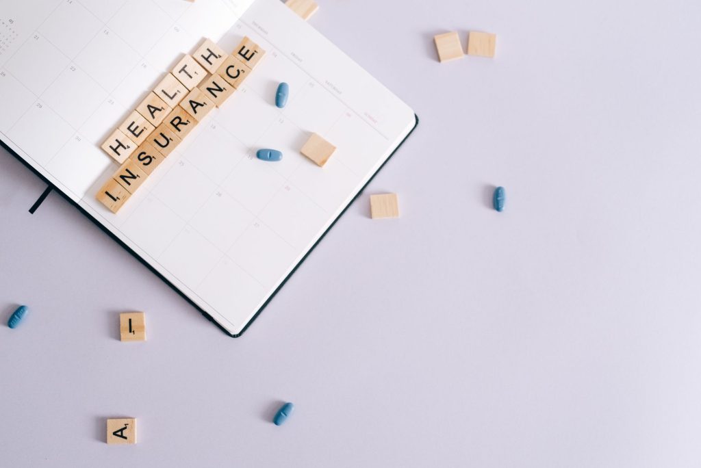 Flat lay of health insurance concept with planner and pills. — Intex Pharma: Cutting-Edge Solutions for Health and Wellness