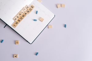 Flat lay of health insurance concept with planner and pills. — Intex Pharma: Cutting-Edge Solutions for Health and Wellness