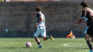 Players engaged in intense soccer action on a sunny outdoor field. Energetic and dynamic sports moment. — NBA Reddit: Connect