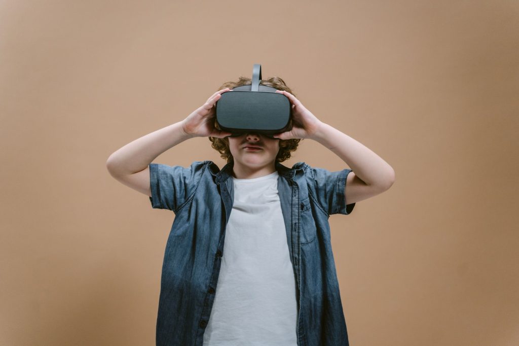 Child in studio using VR headset, engaging with modern technology on a plain background. — Polish yourself for becoming an ex