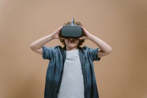 Child in studio using VR headset, engaging with modern technology on a plain background. — Polish yourself for becoming an ex