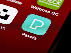 Close-up of various smartphone app icons displayed on a screen, showcasing digital technology and modern lifestyle. — Realize