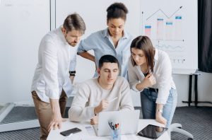 Group of professionals collaborating on a project with graphs in an office setting. — Search engine optimization Services
