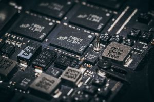 Detailed close-up of electronic microchips on a circuit board, showcasing technology and engineering intricacies. — Selecting