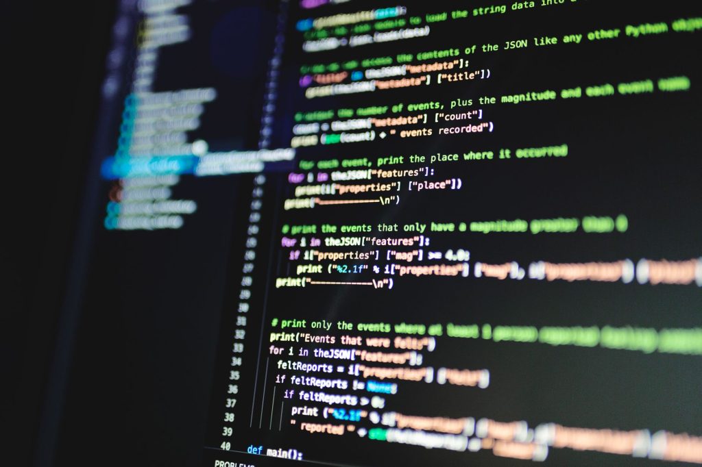 Close-up of colorful programming code displayed on a computer monitor with a dark background. — The sorts of on the internet