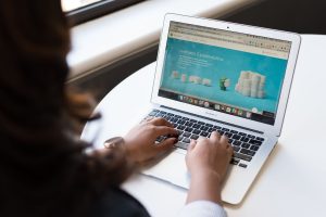 Businesswoman working on laptop with Android 6.0 Marshmallow webpage open. — Transferring Becomes Convenient With The Help Of