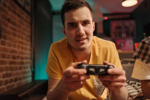 Focused young man enjoying video games with a controller indoors. — Unlock the Secret: Easy-to-Break Slot Games on One Websit