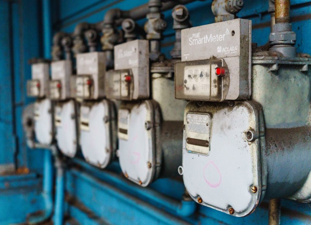 Multiple smart utility meters lined up on a blue industrial wall. — Vital Factors to think about in an Ipad Repair center