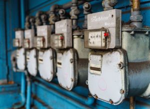 Multiple smart utility meters lined up on a blue industrial wall. — Vital Factors to think about in an Ipad Repair center