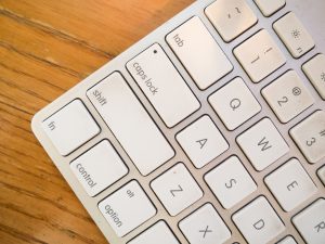 A detailed close-up of a modern computer keyboard on a wooden desk. — Ways to monitor cryptocurrency transactions in your wal