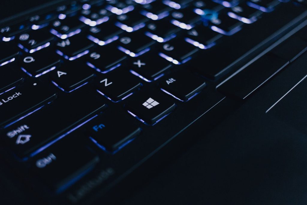 Detailed view of an illuminated laptop keyboard showing individual keys and backlight effect. — Work From Home Online Marketi