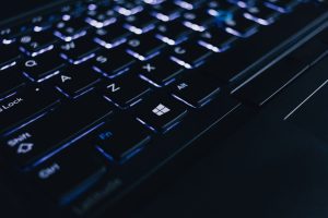 Detailed view of an illuminated laptop keyboard showing individual keys and backlight effect. — Work From Home Online Marketi